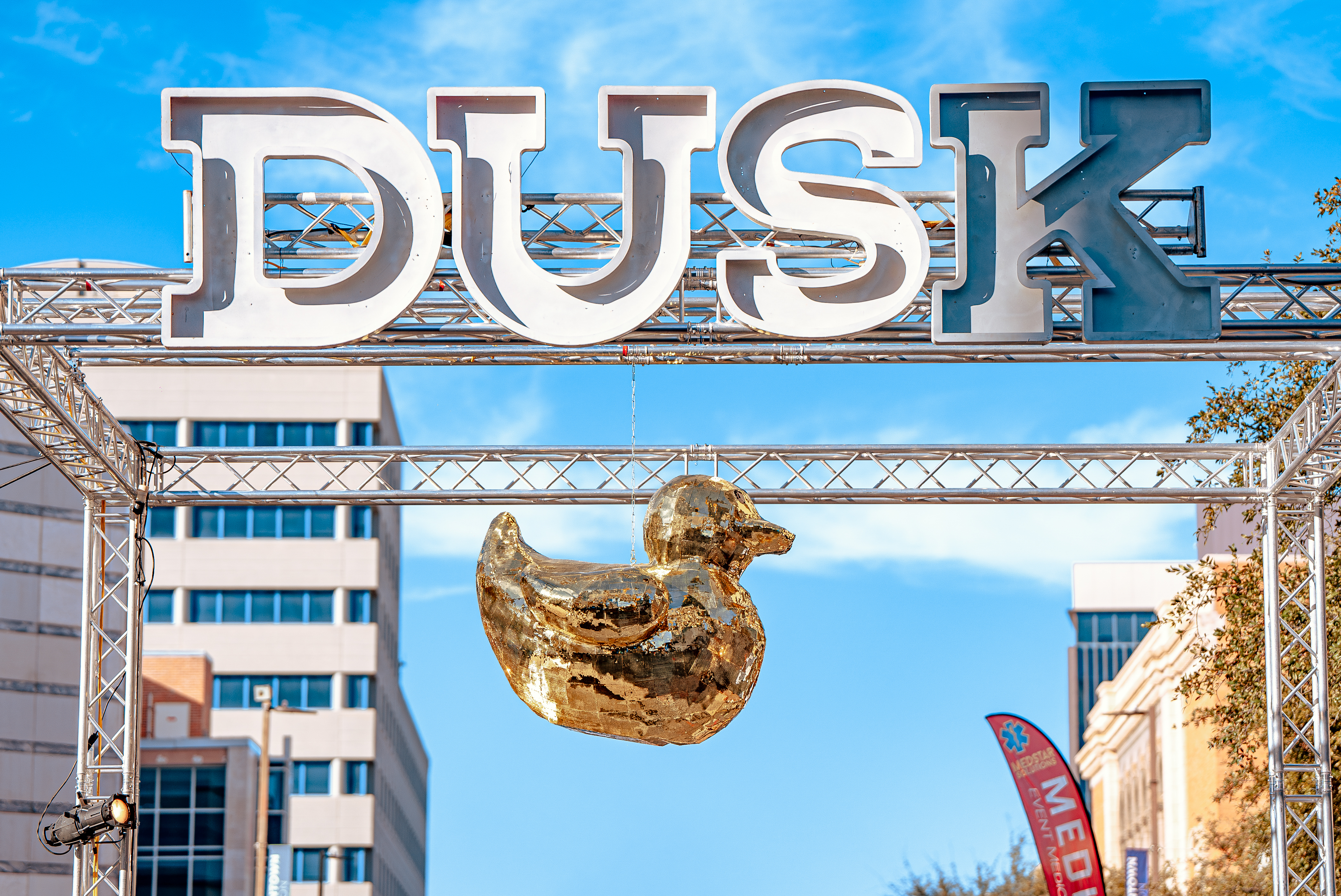 The DUSK festival entrance sign and its signature giant duck installation in downtown Tucson